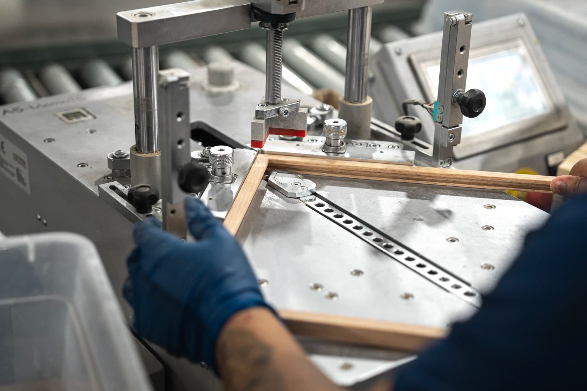 An Artelo team member assembling an oak frame